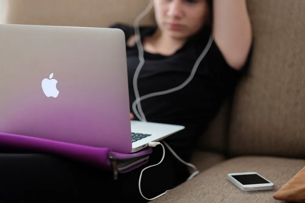 Student in front of laptop wearing headphones